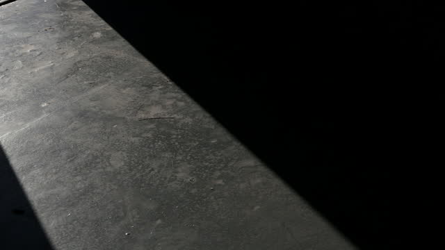 Sunlight Entering through the Door of an Airplane Hangar While Opening the Gate. Low Angle View. 4K Resolution.