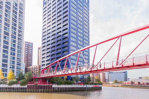public single span pedestrians foot bridge over river lea links east london city Island apartment housing and offices to canning town dlr station, october 22, 2022 in london, united kingdom
