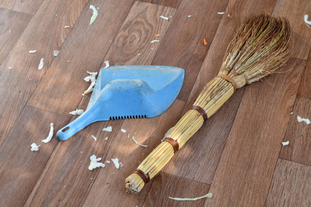 istock A broom and a dustpan are on the floor. 1448201664
