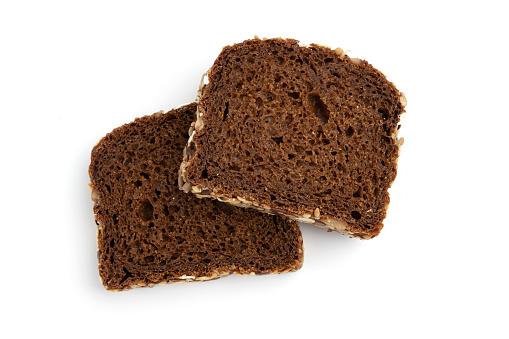 two slices of rye bread on white background, top view, fresh delicious homemade healthy baking