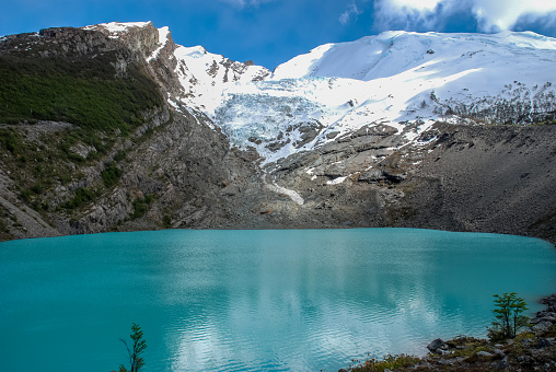 Waters of the Huemul lagoon are surprisingly blue,  few miles north of  El Chalten at the foot of the mountains surrounding the Campo de Hielo Sur
