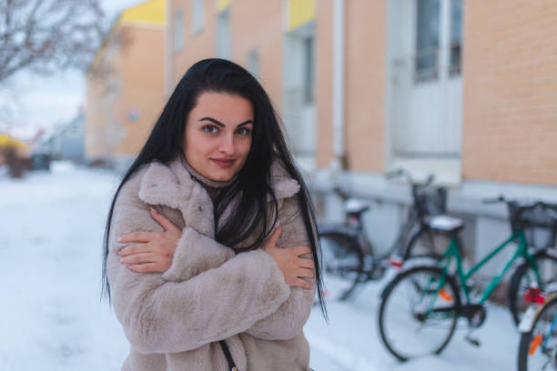 istock Young black haired woman freezing outdoors in the snow 1448212954
