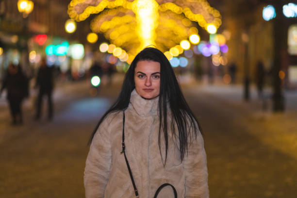 istock Beautiful young woman posing outdoors while wearing a thick winter coat 1448213608