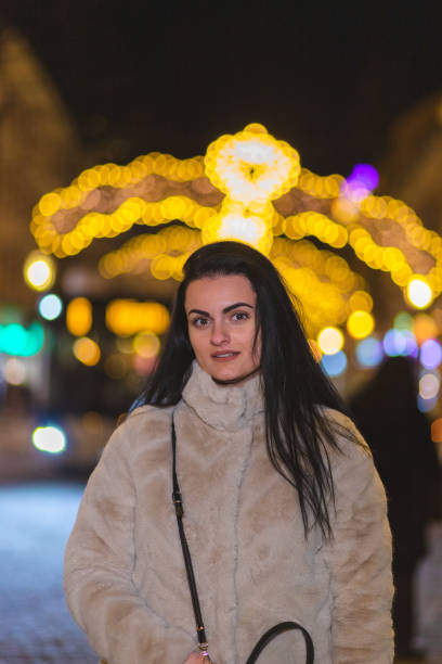 istock Beautiful young woman posing outdoors while wearing a thick winter coat 1448213609