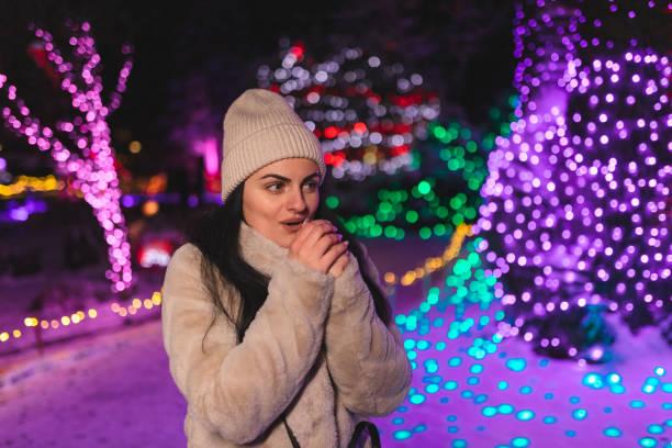 istock Freezing young woman blowing into her hands while being outdoors 1448214002