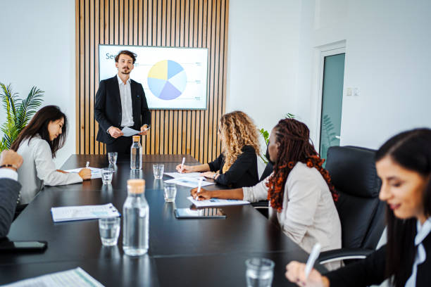 istock Businessman leading business meeting using statistics chart on presentation TV 1448217034