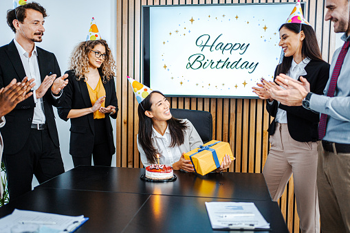 Work colleagues surprising their female colleague with special birthday party in office