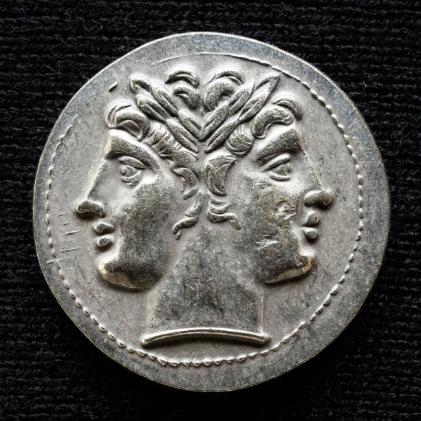 Ancient coin showing two-headed Roman god Janus, 225-214 BC Ancient coin showing two-headed Roman god Janus, 225-214 BC. Old rare money, silver didrachm isolated on dark background, macro. Concept of Rome, valuable coin, past civilization and history. janus head stock pictures, royalty-free photos & images