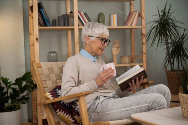 istock Senior woman enjoying reading at home 1448225546