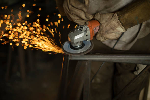 Sparks from grinding steel. Man works in garage. Metal treatment. Sparks from grinding steel. Man works in garage. Metal treatment. Many sparks from steel friction. steel grinding stock pictures, royalty-free photos & images