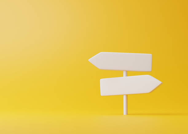 istock White direction sign on a yellow background in pastel colors 1448226057