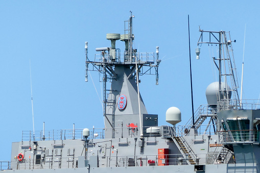 The superstructure of HMAS Choules of the Royal Australian Navy docked at Garden Island in Sydney Harbour.  This image was taken from Mrs Macquarie's Chair on a sunny afternoon in early Summer.