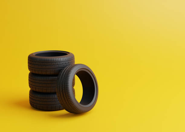 istock Stack of car tires on a yellow background 1448227199