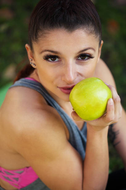 Young woman eating an apple