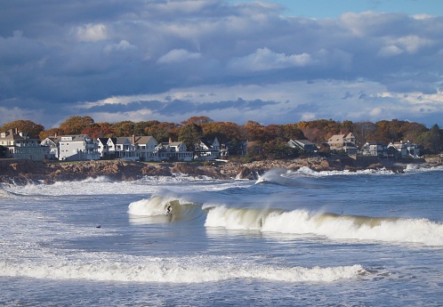 A surfer catches a wave during autmn at Short Sands Beach in York, Maine