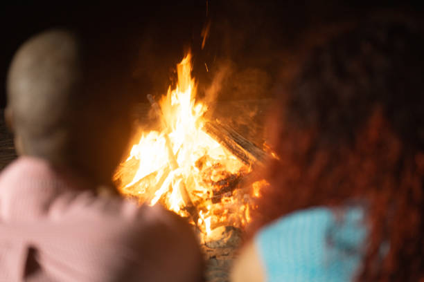 Couple friends front a bonfire.