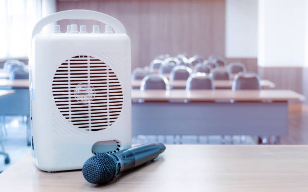 Pocket amplifiers and microphones placed on the table in front of the classroom. Pocket amplifiers and microphones placed on the table in front of the classroom. interview seminar microphone inside of stock pictures, royalty-free photos & images