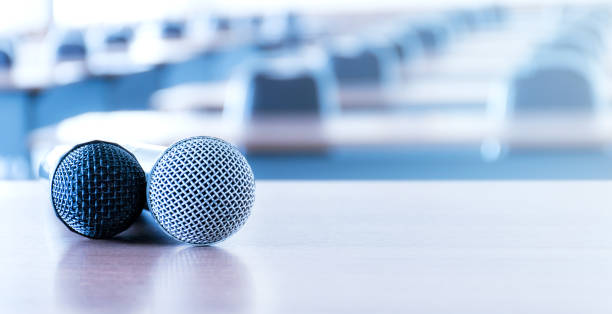 istock Close up microphone on the speaker table in seminar room 1448245767