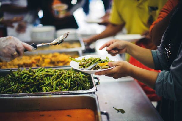 istock Feeding the poor to hands of a beggar, Poverty concept 1448249679