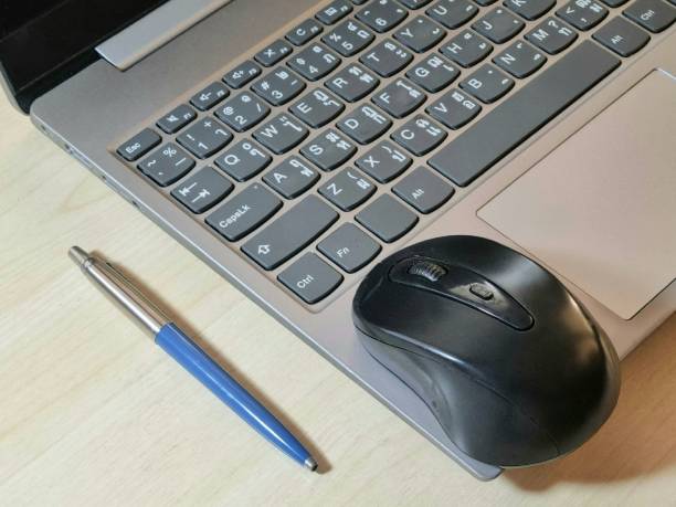 istock Laptop, mouse and glasses on office desk 1448251003