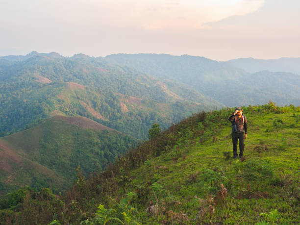 istock Men backpacker are happy and enjoy with sunrise after successful hiking. 1448252936