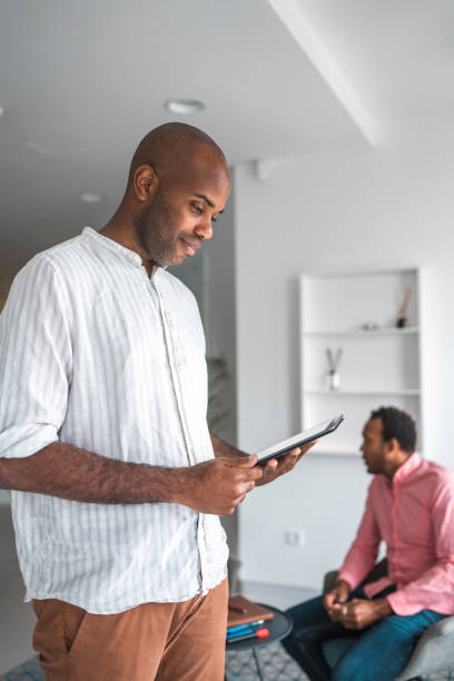 istock Handsome Mid Adult Black Male Working With A Digital Tablet 1448259487