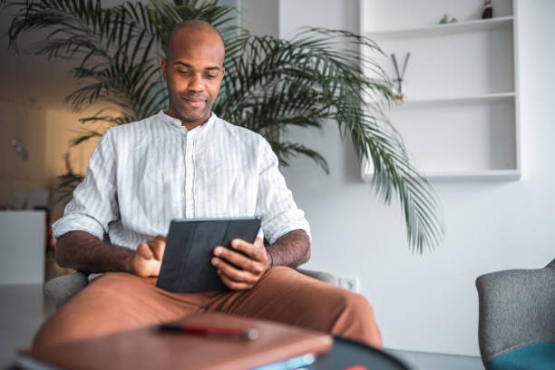 istock Handsome Mid Adult Black Male Working With A Digital Tablet 1448259505