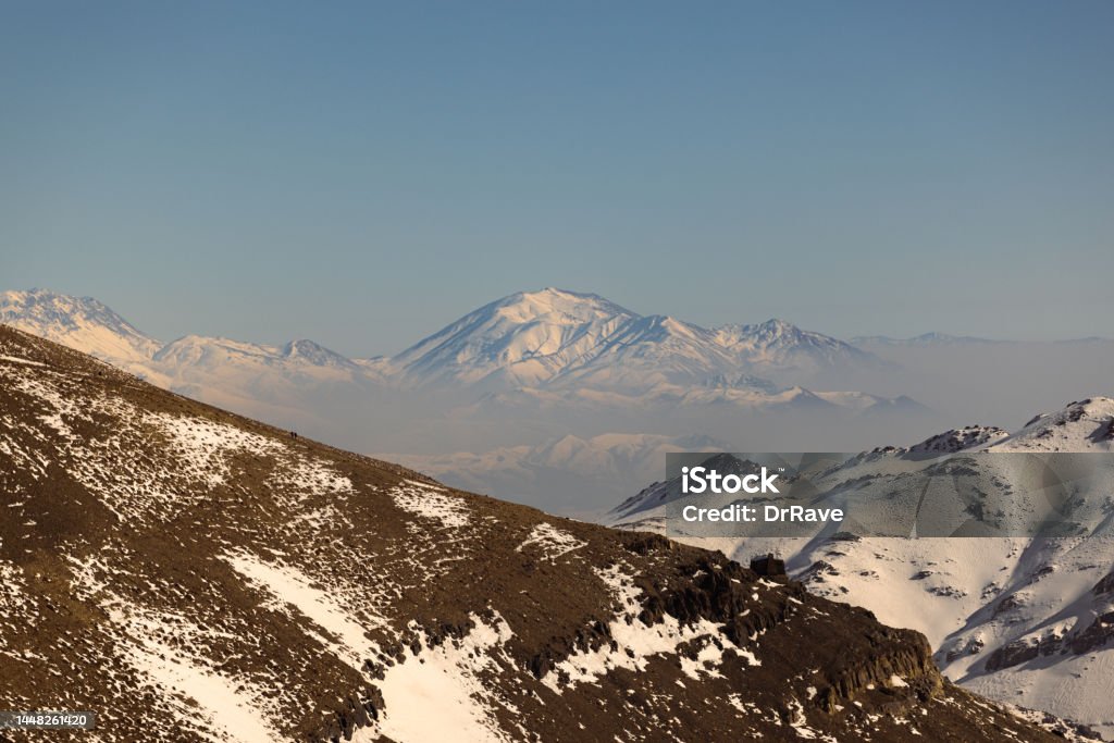 Aerial View of Tochal mountain peaks, Alborz mountain range, Tehran Iran Aerial View of Tochal mountain peaks, Alborz mountain range, Tehran Iran. Famous for its snow peaks for skiing. Iran Stock Photo