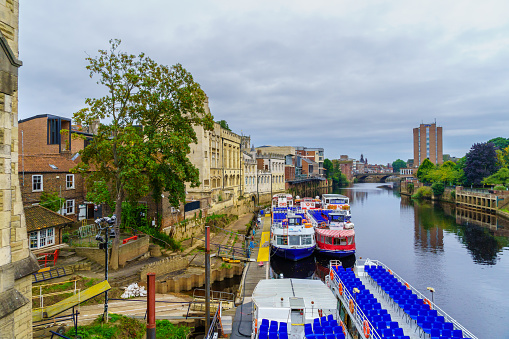 York, UK - September 22, 2022: View of the River Ouse, with boats and buildings, in York, North Yorkshire, England, UK
