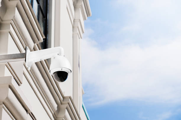 istock Modern public CCTV camera on ancient building wall with bright sky background. Intelligent reccording cameras for monitoring all day and night. Concept of surveillance and monitoring with copy space. 1448264641