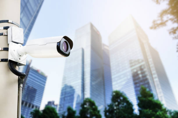 istock Modern public CCTV camera on electric pole with blur building background. Recording cameras for monitoring all day and night. Concept of surveillance and monitoring with copy space. 1448265287