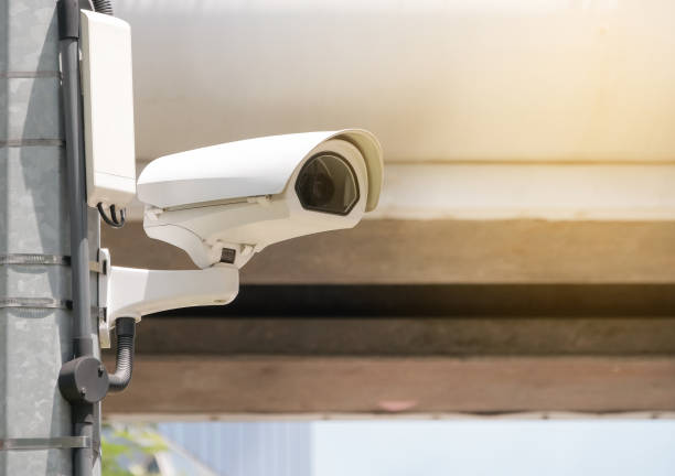 istock Modern public CCTV camera on electric pole with blur building background. Recording cameras for monitoring all day and night. Concept of surveillance and monitoring with copy space. 1448265507