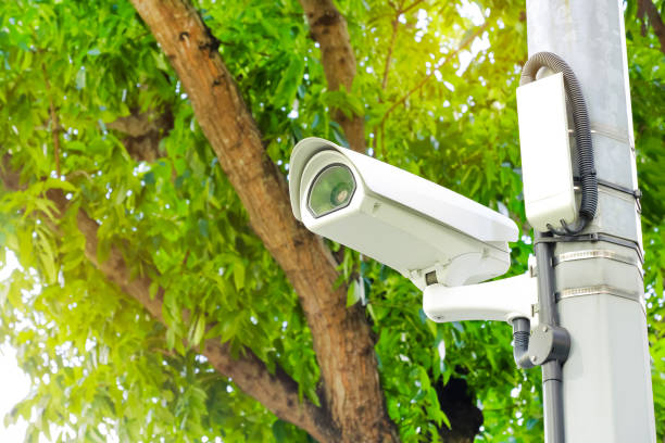 istock Modern public CCTV camera on a electric pole with blurred natural background. 1448266097