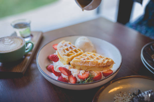 waffle pancake desert with vanilla ice cream, fresh strawberry and honey syrup Picture of waffle pancake desert with vanilla ice cream, fresh strawberry and honey syrup Eggo Waffle stock pictures, royalty-free photos & images