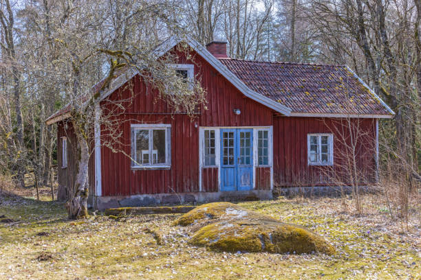 istock Idyllic old red cottage on a sunny spring day 1448272727