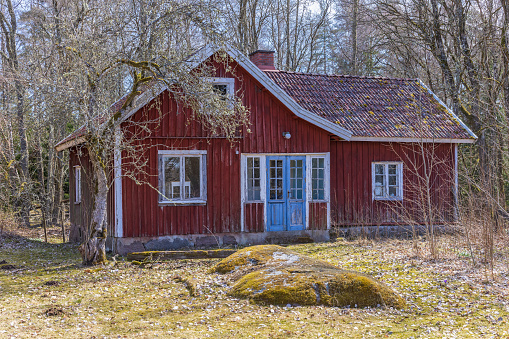 Idyllic old red cottage on a sunny spring day