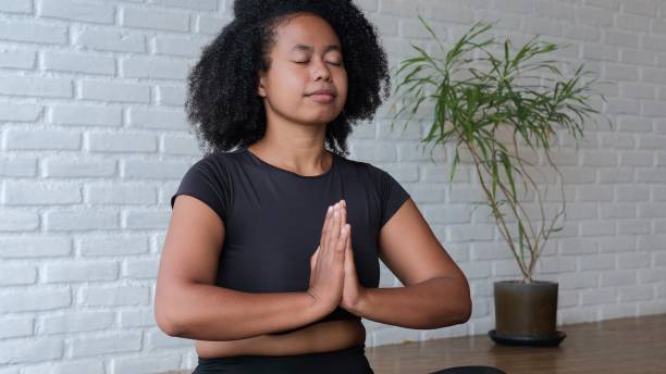 istock A swarthy woman meditates. Keeps the spinal column straight so that nothing interferes with breathing. My body relaxed as much as possible. Quiescent state. A woman enjoys meditation. 1448272892