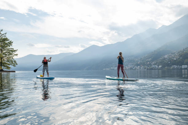 istock Father and daughter on stand up paddle boards at sunrise 1448273832
