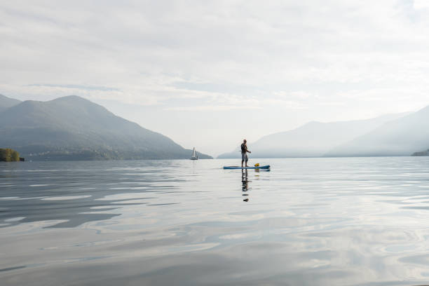 istock Active senior doing stand up board o a lake 1448273916