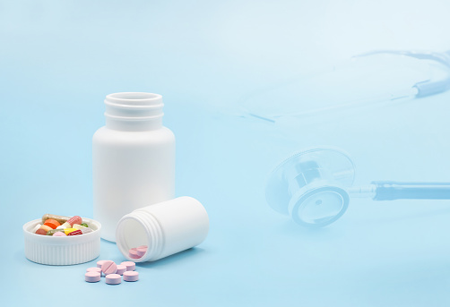 Double exposure on various pills with medicine bottle and stethoscope. Medical health check and health care concept. With copy space.