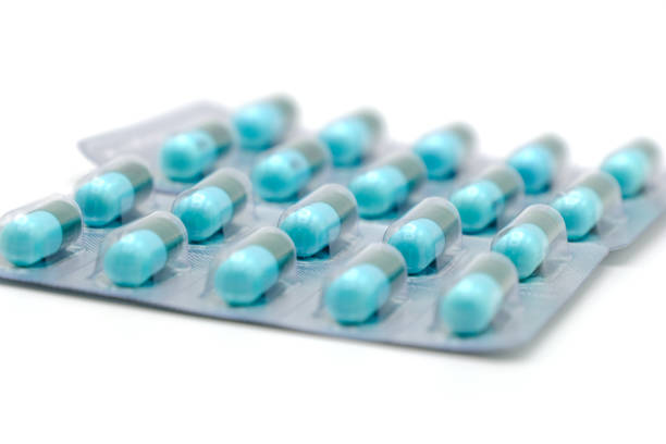 istock Close up on tablets and capsules pill in blister packaging arranged on white background, Pharmaceutical industry concept. Pharmacy drugstore, Amoxicillin capsule pills. 1448276769