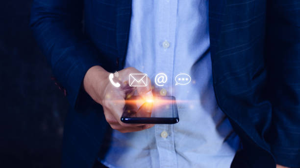 istock Customer support hotline Contact us people connection, Businessman using pointing touching Smart Phone with email, call phone, address, Chat message icons, Communication concept 1448278101