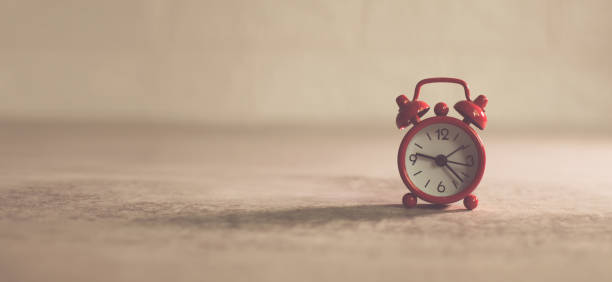 istock Red retro alarm clock on the floor, time for do something concept 1448281157