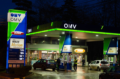 Bucharest, Romania - December 12, 2022: A OMV gas station is seen at night in Bucharest Editorial stock photo - stock image