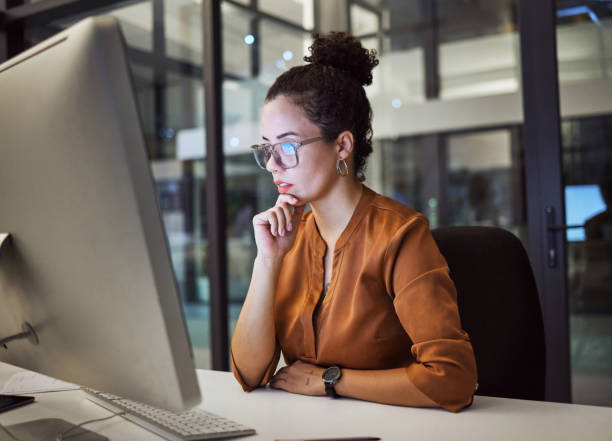 istock Woman, computer and office with glasses show reflection on face while working overtime. Girl, thinking and idea read analytics, email or communication online at work late at business in the night 1448282611