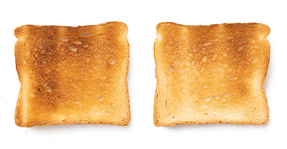 Set of sliced roasted toasts bread isolated on white background. Pieces of lightly toasted white bread. Close-up of toast. Top view.