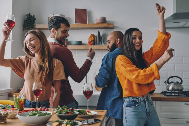 istock Beautiful young people dancing and smiling while enjoying party at home together 1448284579