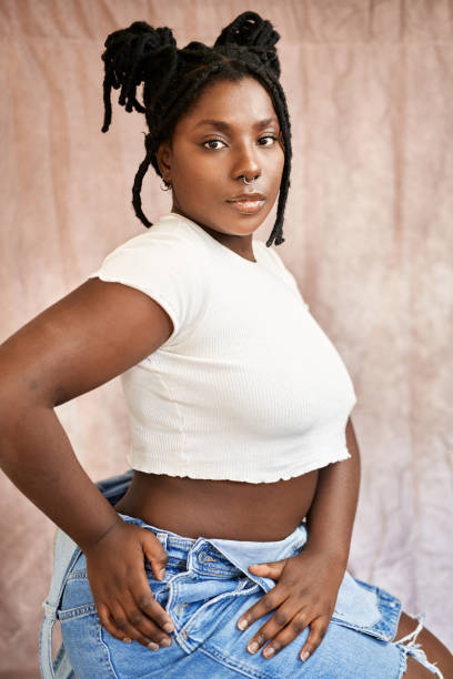 istock Stylish african young woman sitting while looking at camera 1448286342