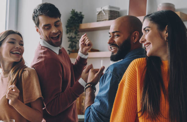 istock Beautiful young people dancing and smiling while enjoying home party together 1448287510