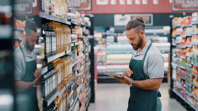 Supermarket, tablet and man take product inventory of food,  oil or stock for grocery store database, retail shopping or digital records. Commerce, manager checklist and clerk counting shelf produce